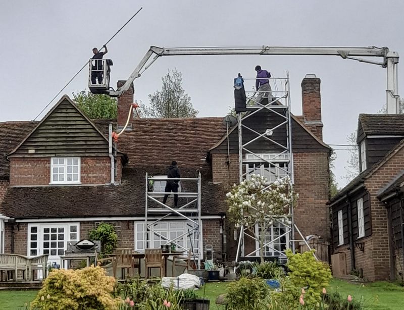 The Roof Moss Cleaners using cherry picker and scaffolding to clean roof safely and professionally in Yateley, Hampshire